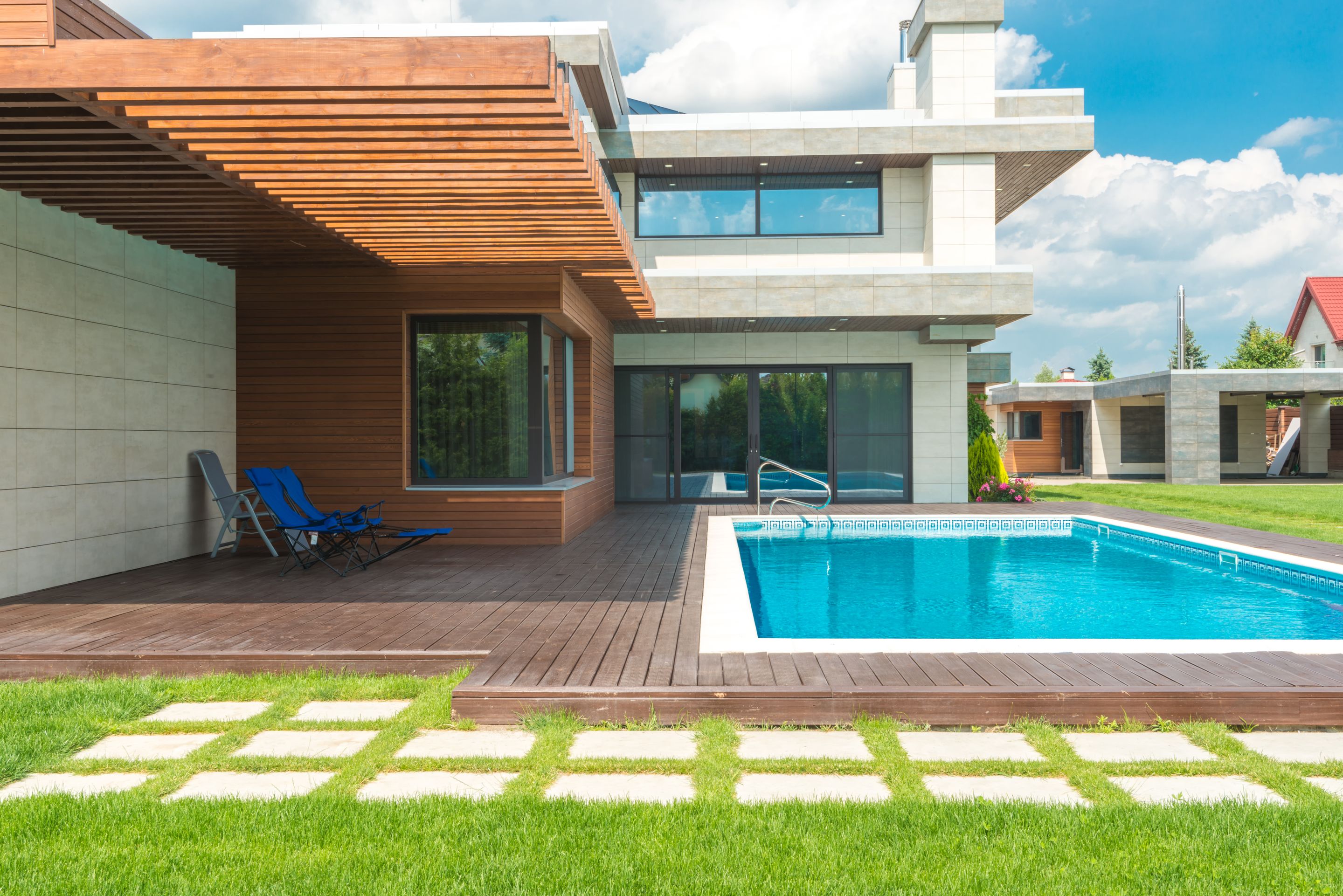 A modern single-family house with a rectangular backyard pool