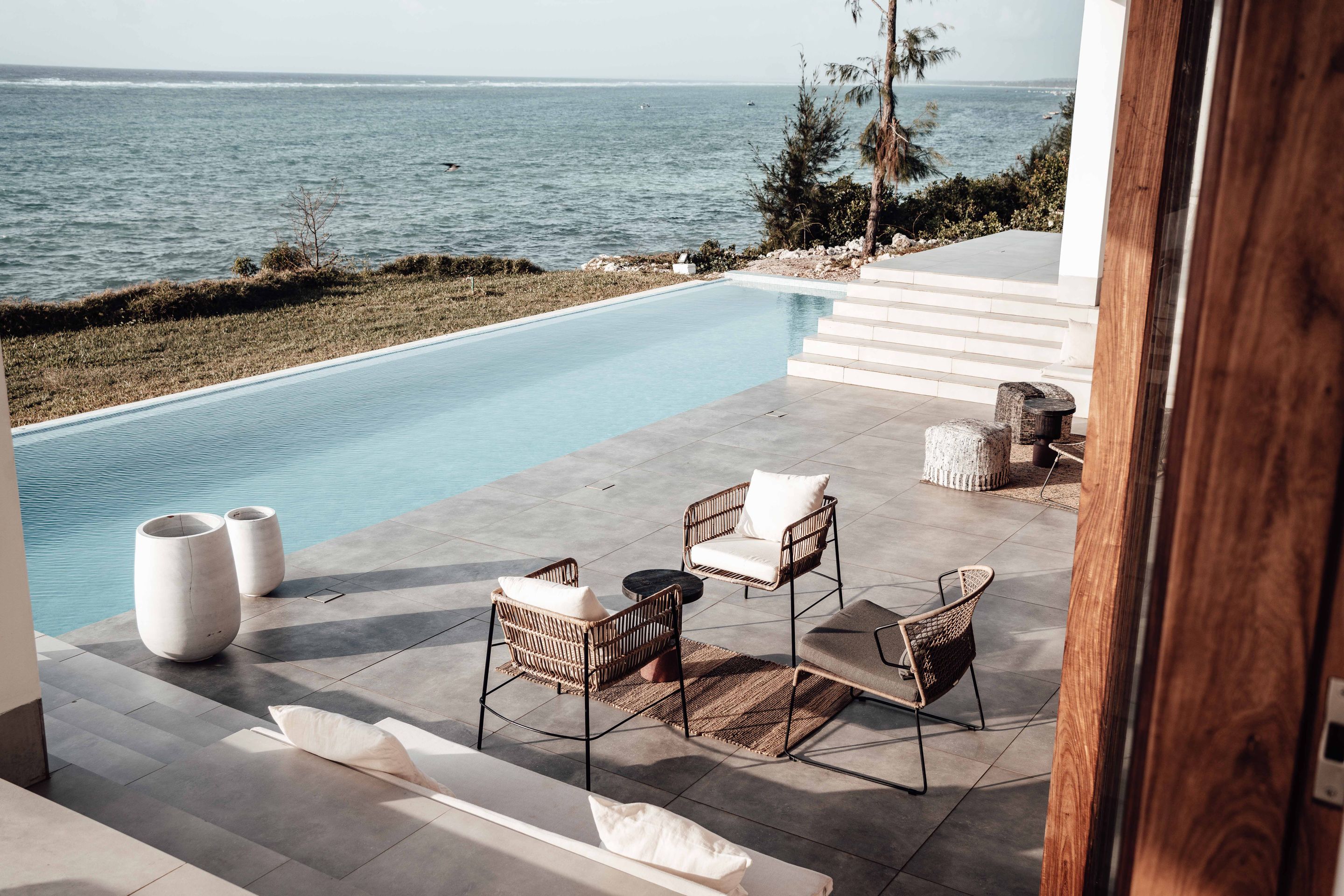 A poolside patio looking out over the open ocean